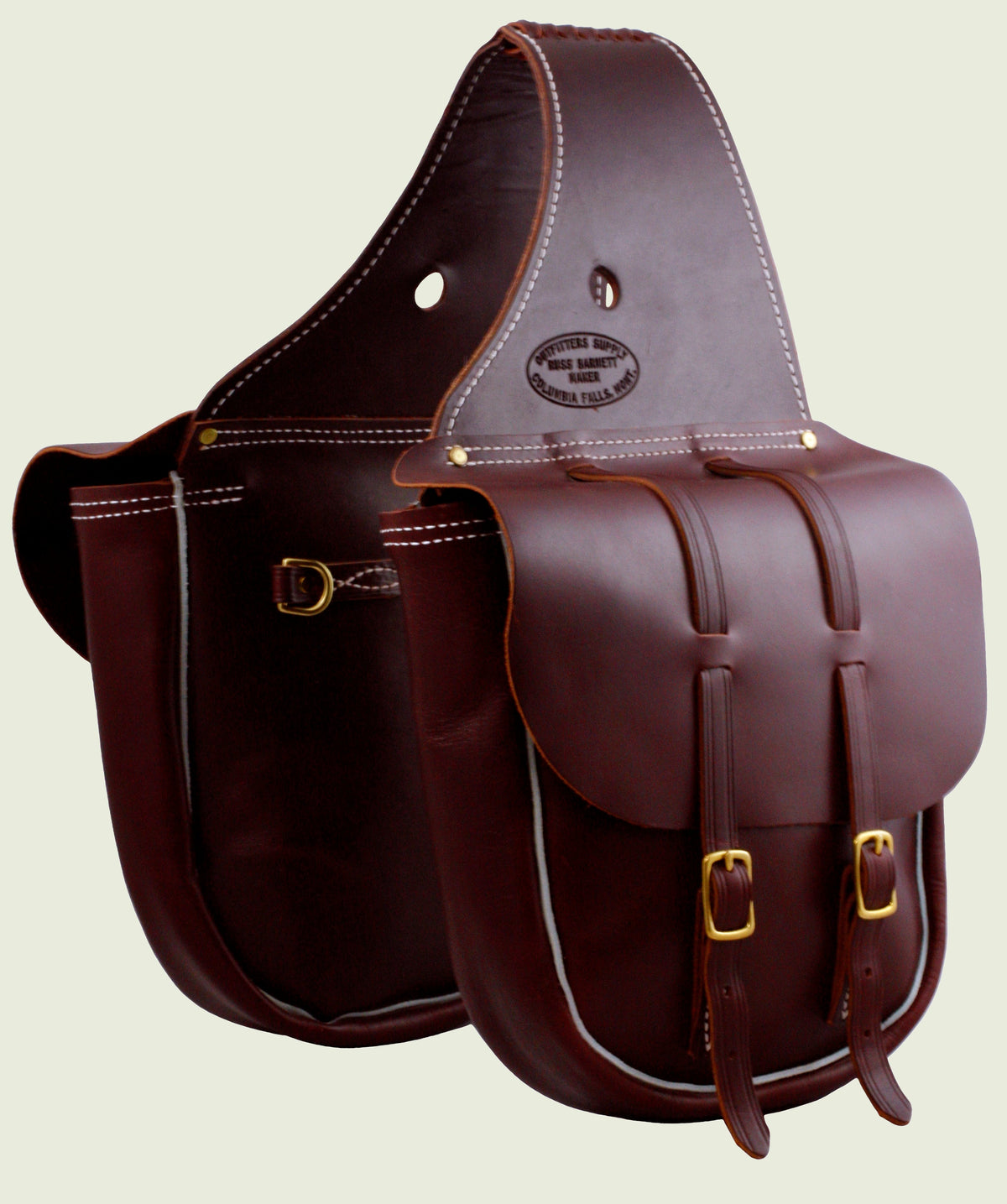 Dark brown saddle bags with two gold buckles, pale piping and stamped badge